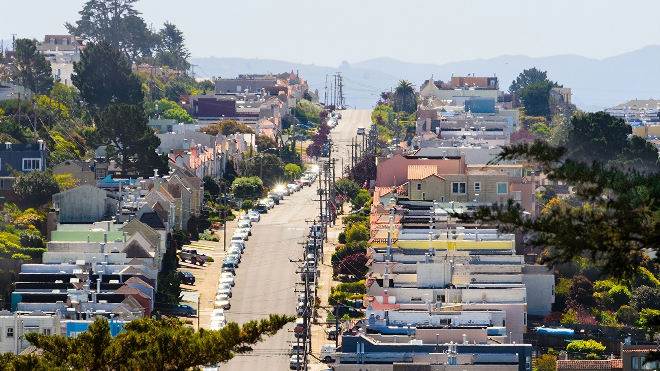 A view of a hilly street in the Inner Sunset, seen zoomed-in from a distance