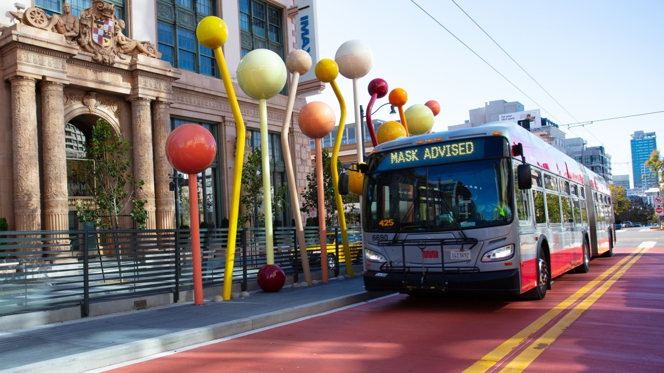 Van Ness bus rapid transit in front of outdoor art. 