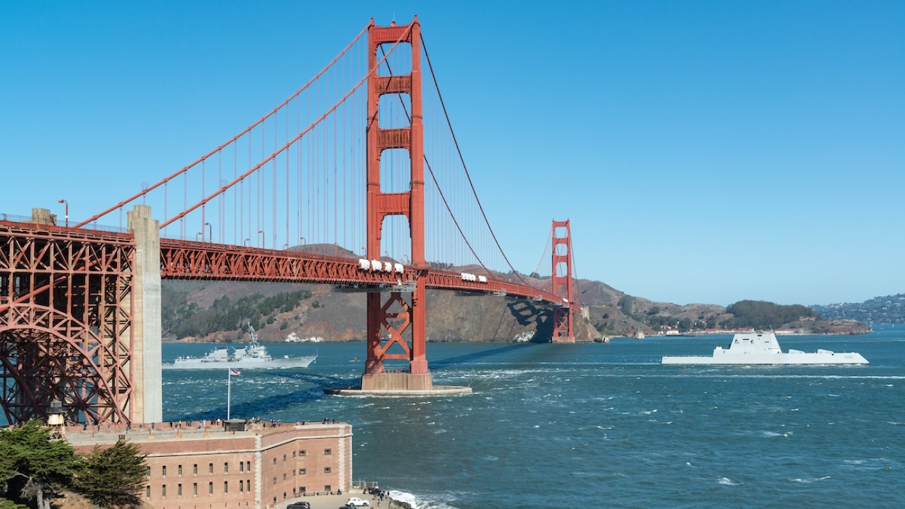 View of the red Golden Gate Bridge with blue skies and blue water