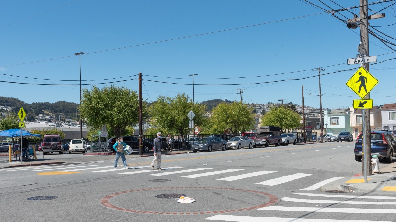 Intersection of Apollo and Williams in the Bayview District, pedestrians cross in crosswalk 