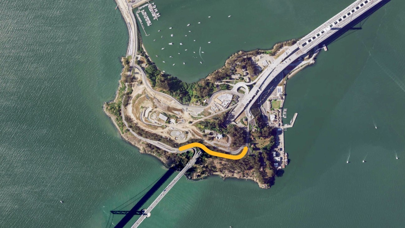 A satellite photo of Yerba Buena Island with north pointing up. The Hillcrest Road project area, which runs along Hillcrest Road from the westbound bridge on-ramp to Forest Road, is highlighted in yellow.
