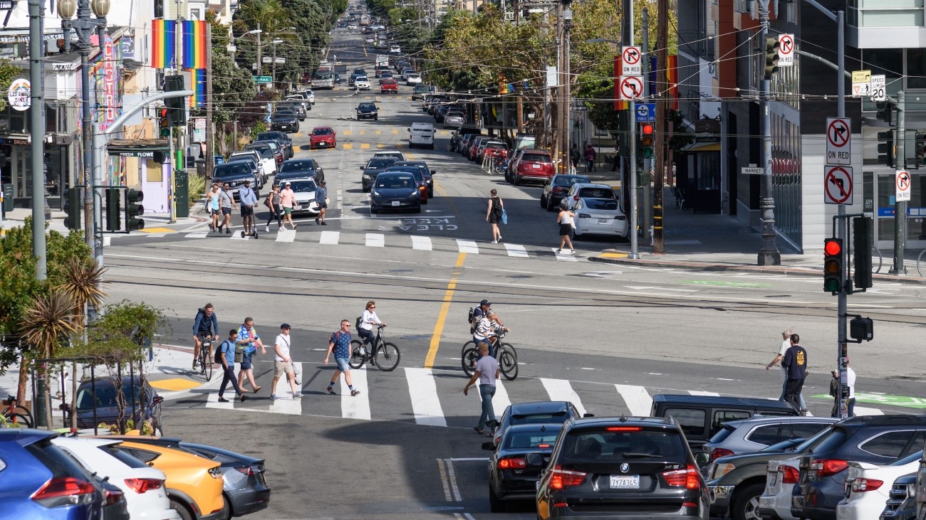 New painted crosswalks along Market Street with pedestrians and vehicles around