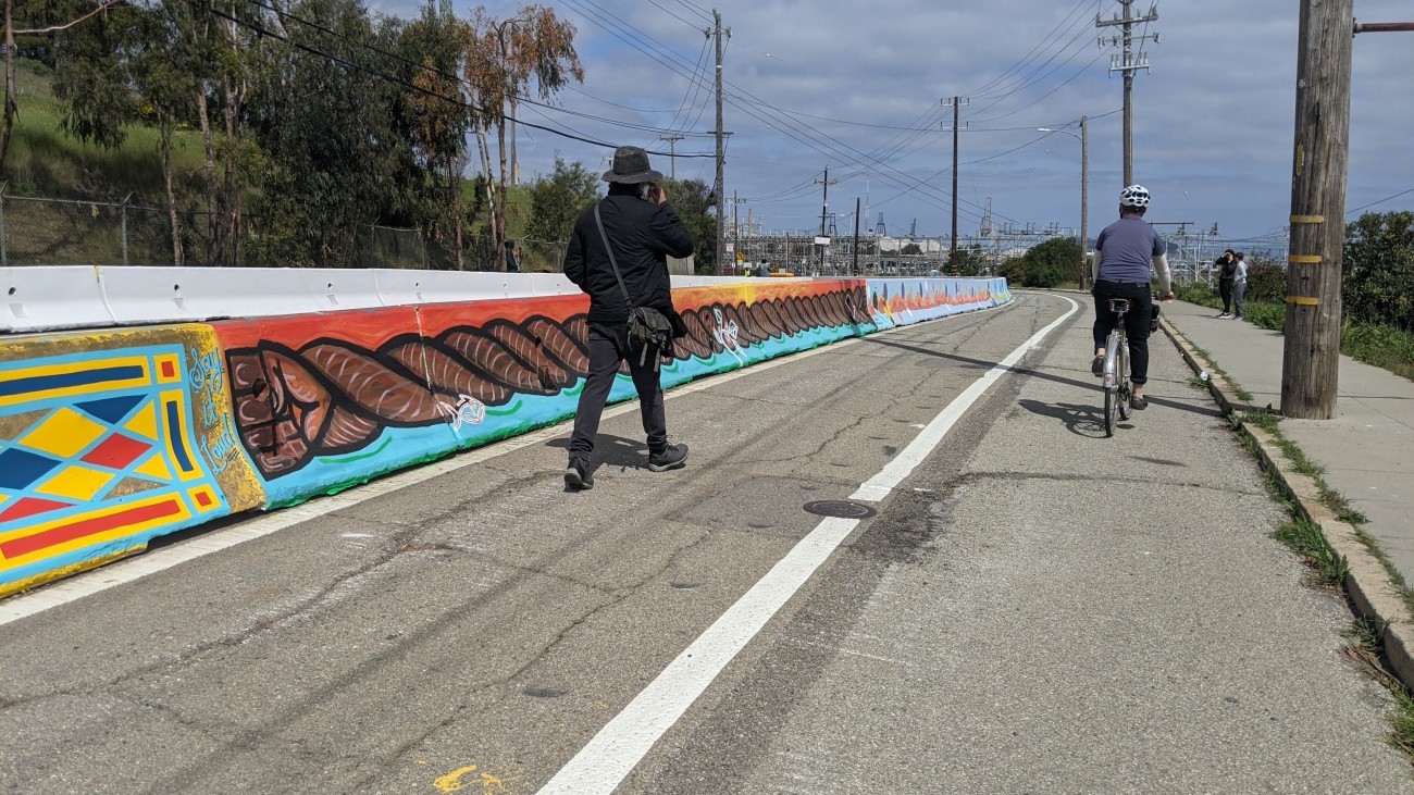 Pedestrian and cyclist along a protected bikeway