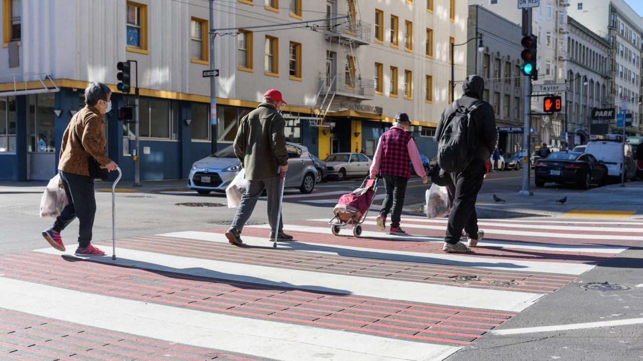 Pedestrians walking on a decorative crosswalk