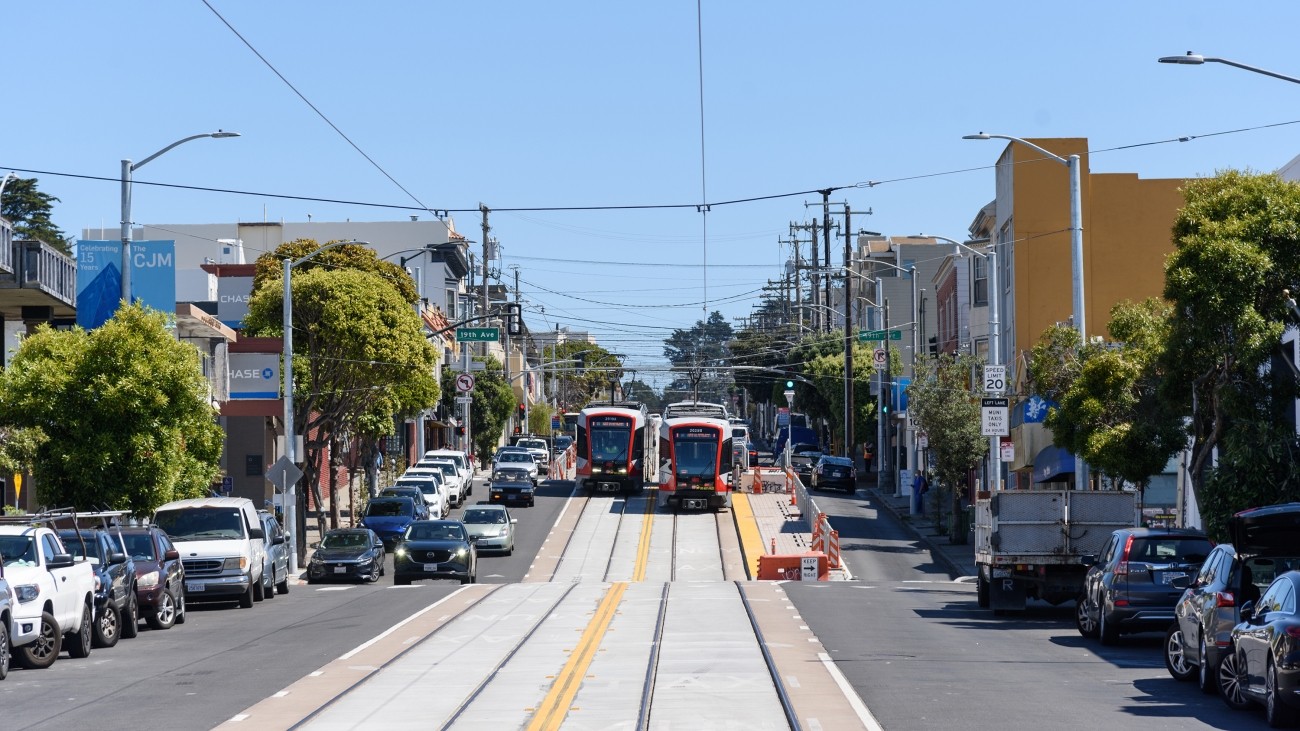 Two Muni Metro light rail vehicles pass each other on Taraval at 19th Avenue