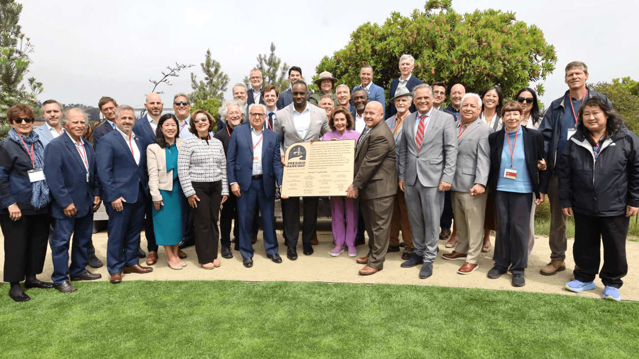 City officials, transportation officials and staff gathered with a plaque to celebrate 10 years of the Presidio Parkway