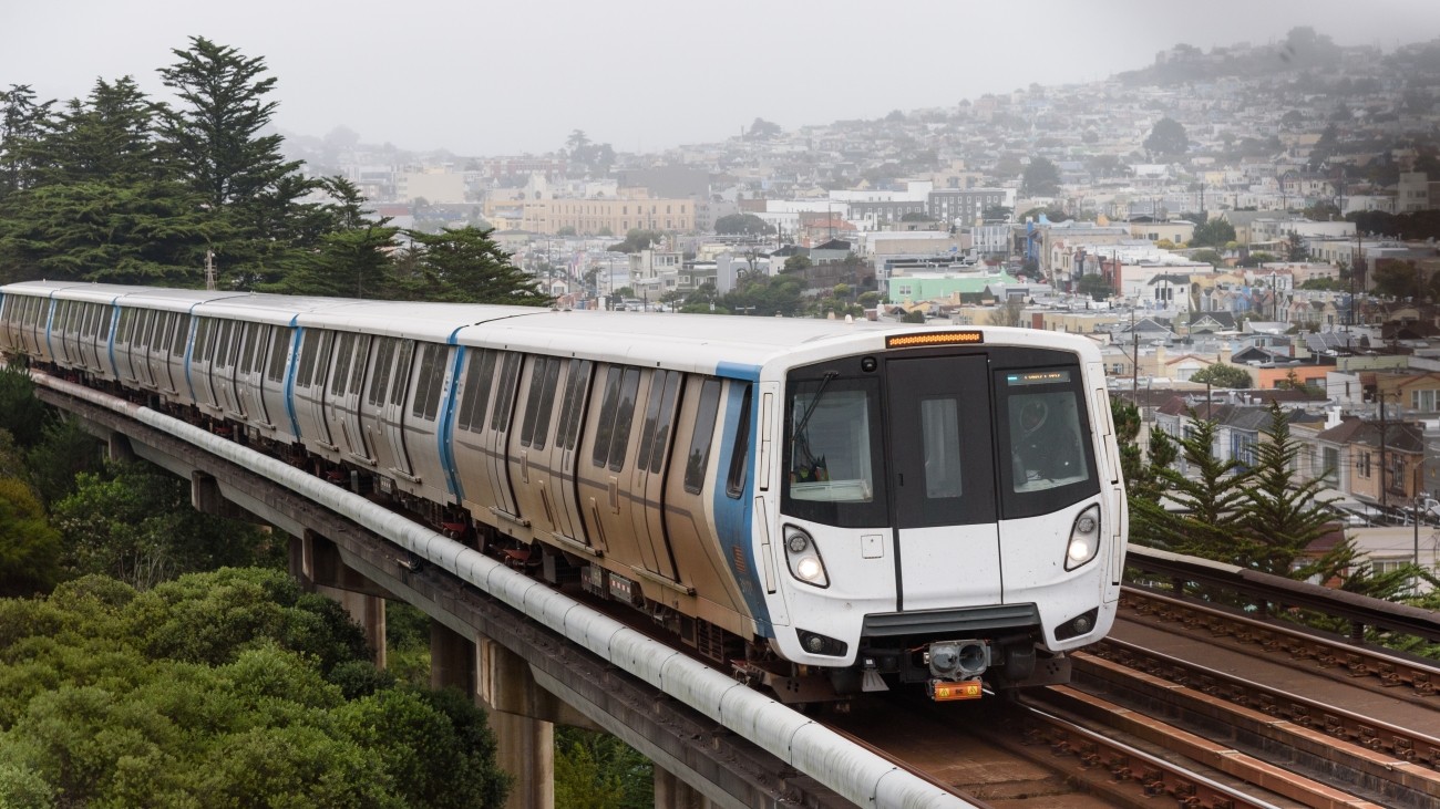 A BART train on overhead tracks traveling through San Francisco