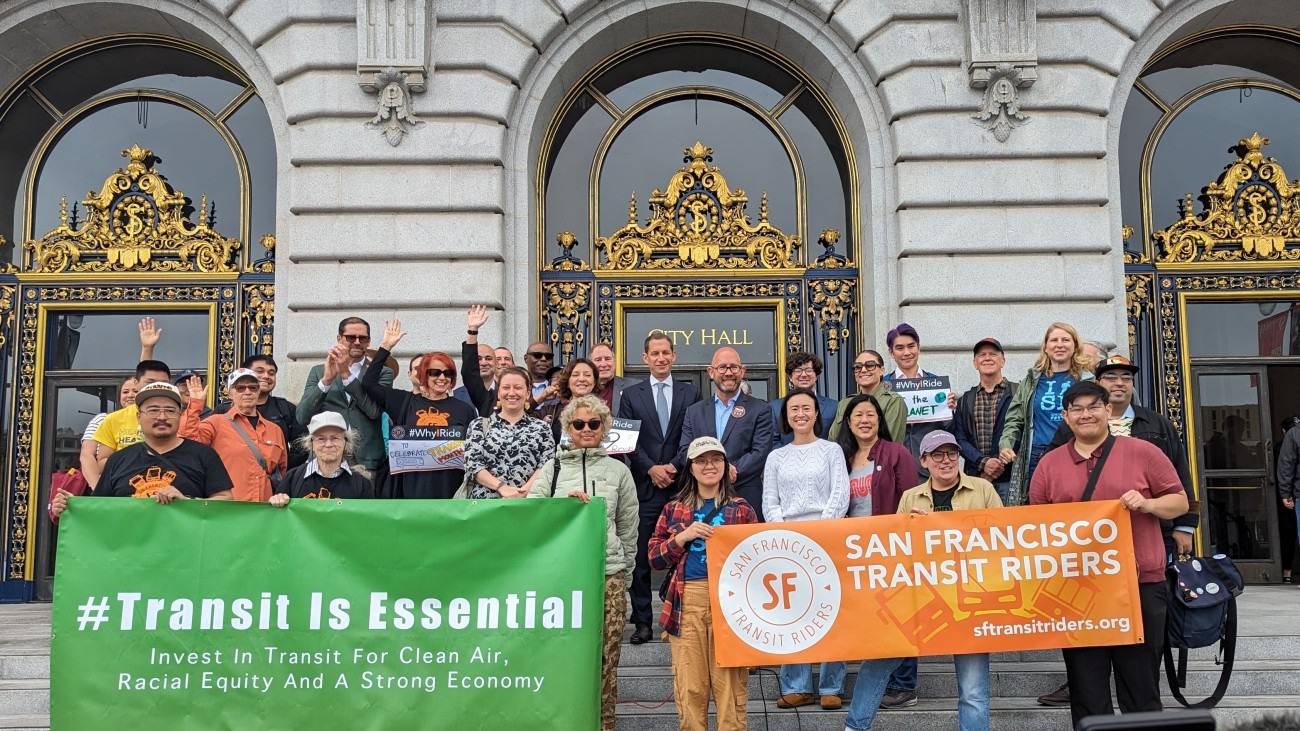 People gathered on the steps of City Hall to celebrate Transit Month