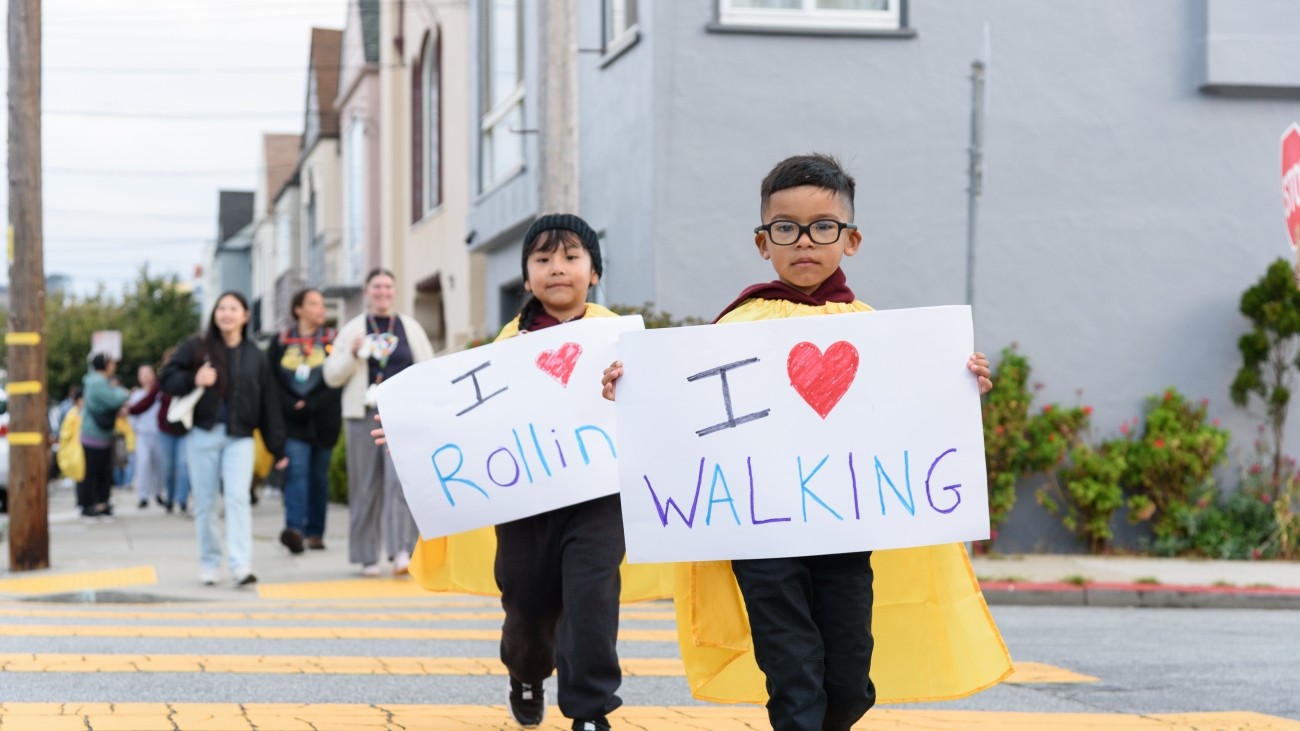 Students holding I love walking and rolling signs