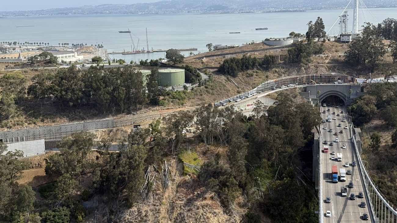 Aerial view of retaining wall with Bay Bridge in foreground.