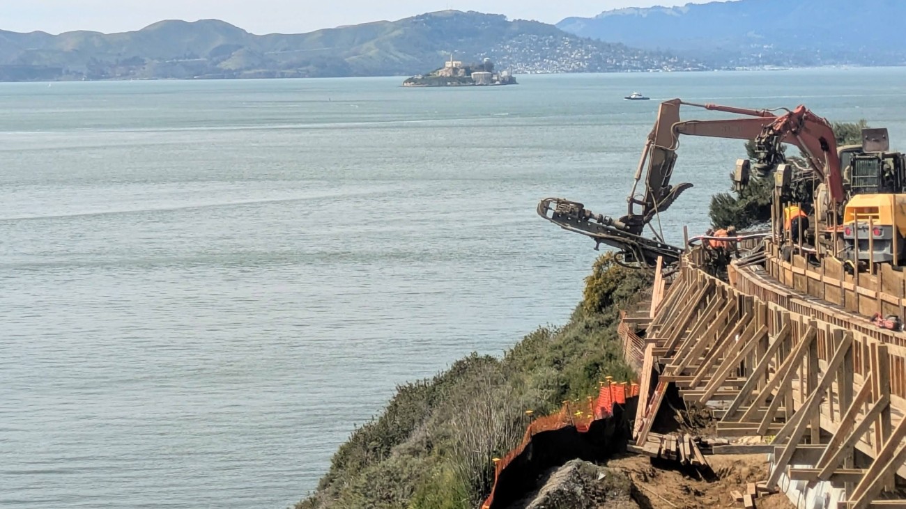 Retaining wall and preliminary bridge construction with the Bay in the background.