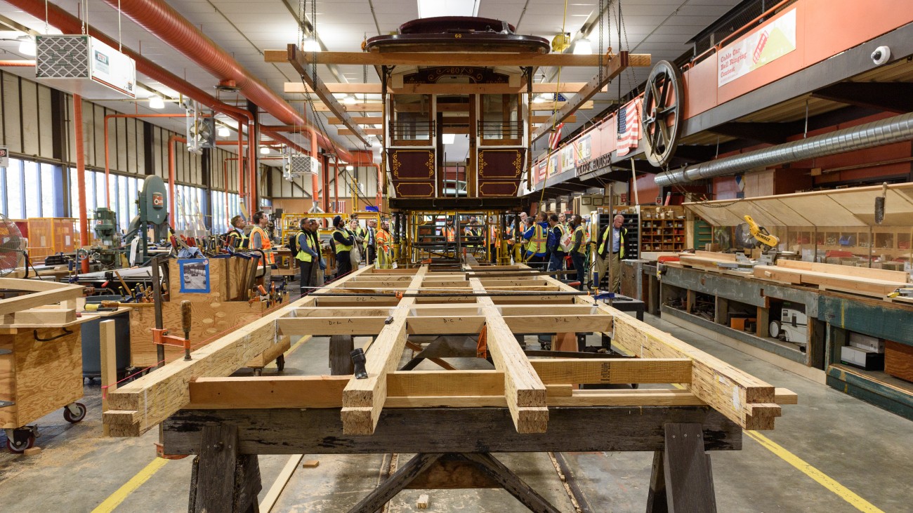 Cable car elevated in SFMTA restoration workshop 
