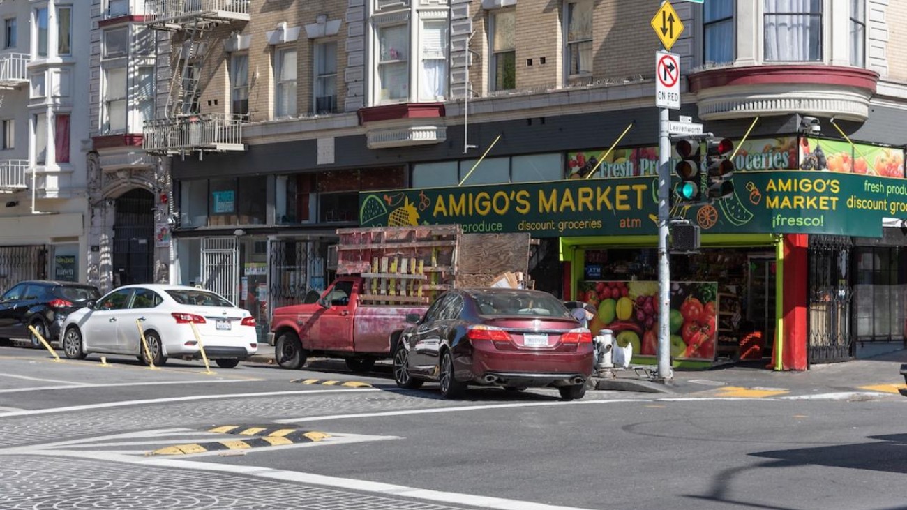 Car making left turn with waist-high delineators and speed bumps