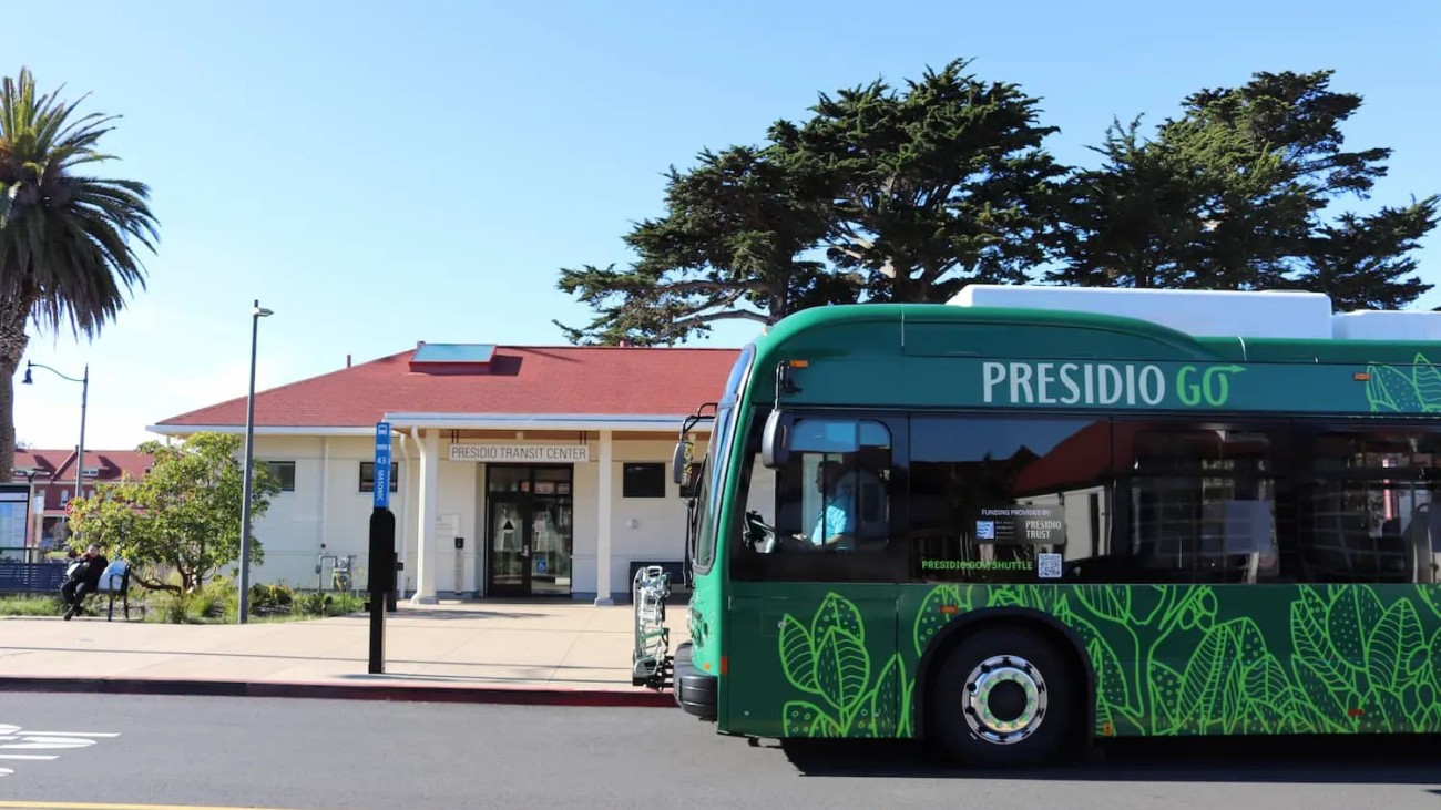A Presidio GO battery electric bus is parked in front of the Presidio Transit Center.