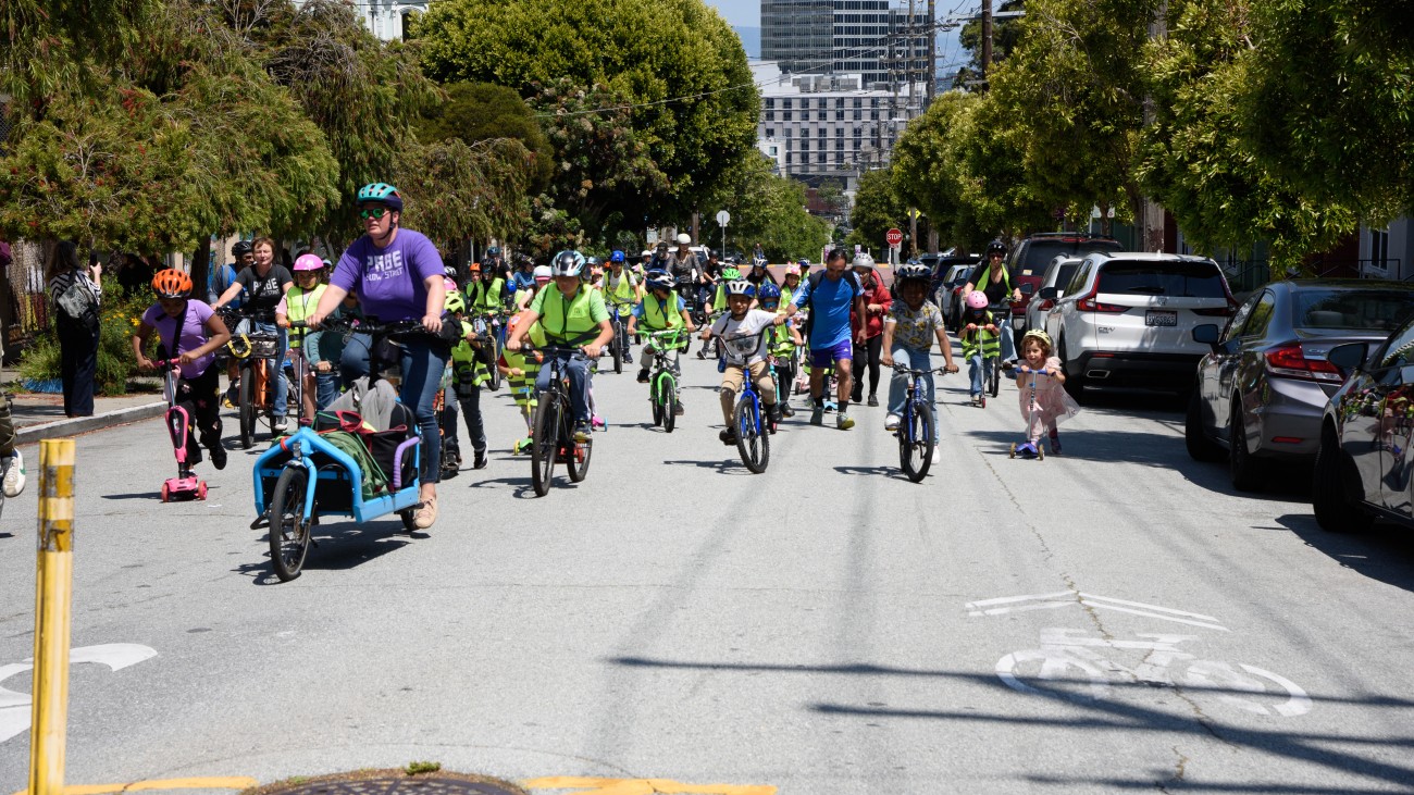 Students and adults on group bike ride