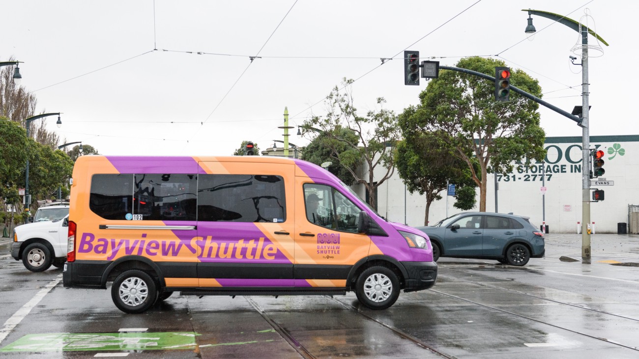 Purple and orange Bayview Shuttle van on the road