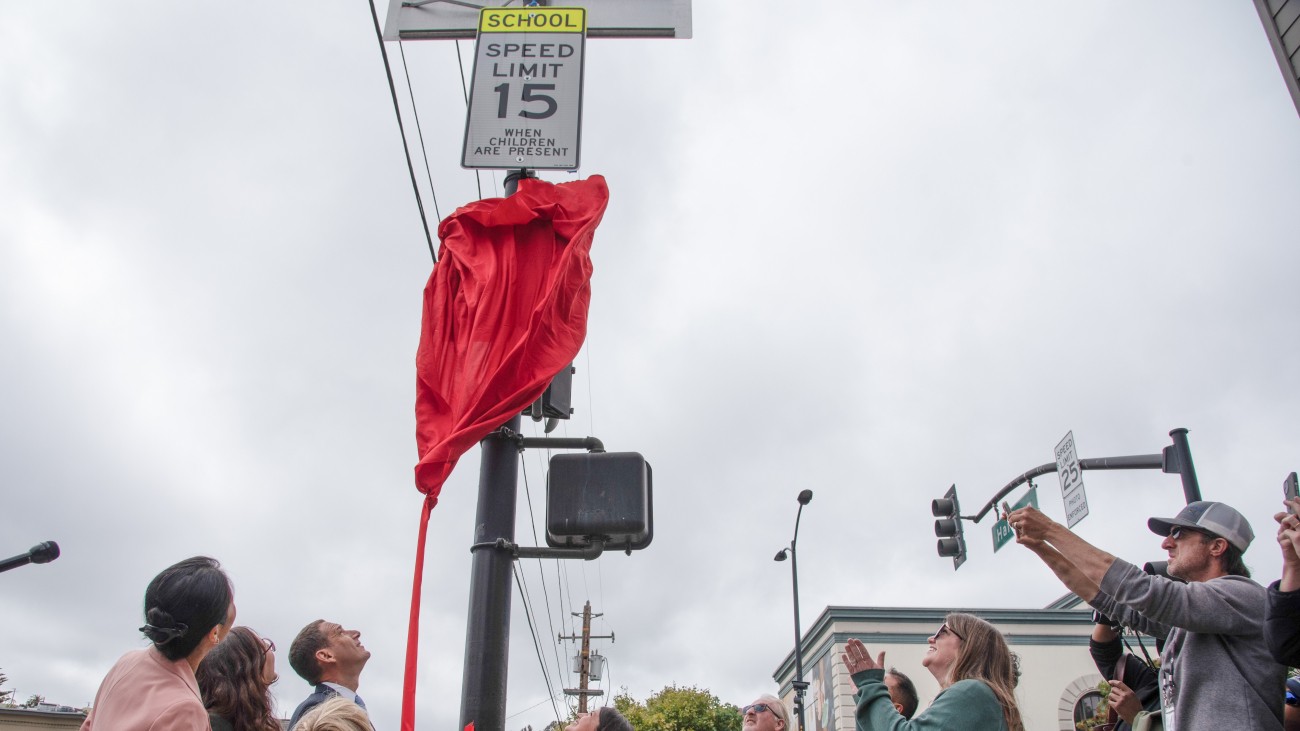 The mayor and school community unveiling new school speed limit sign