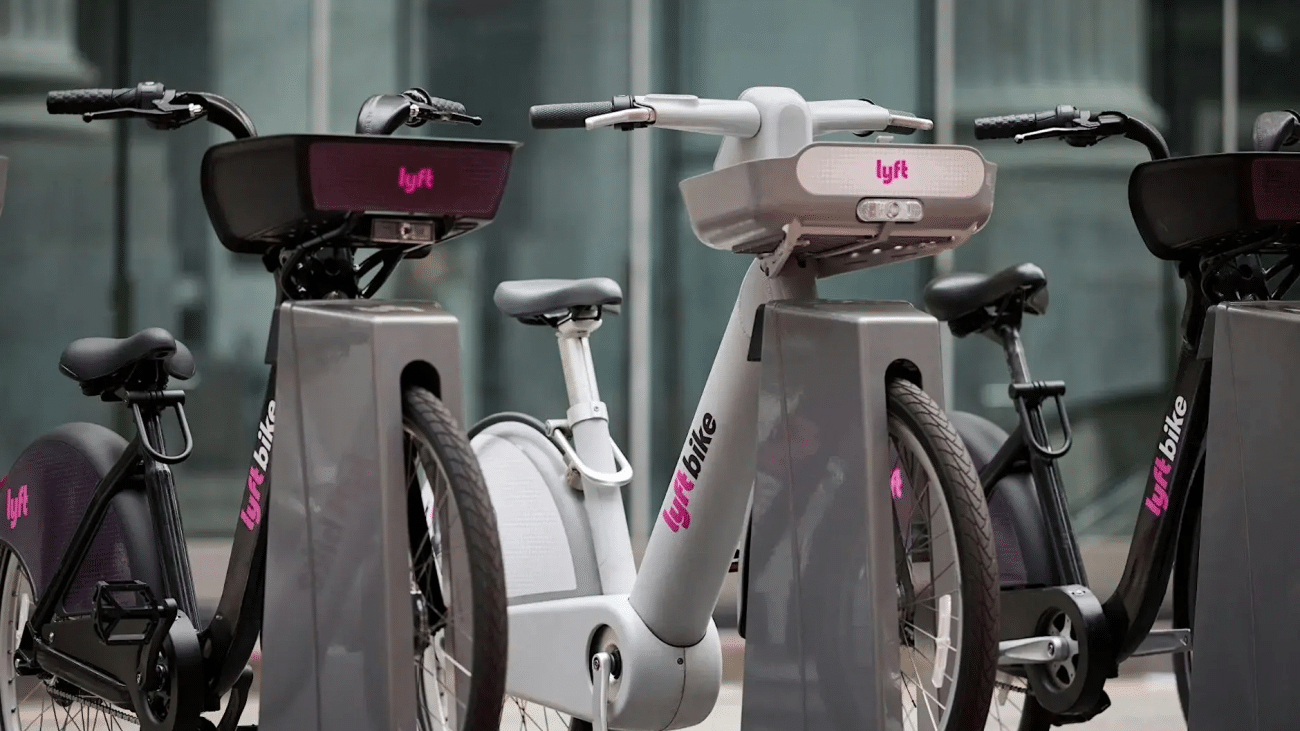 Three parked Lyft Bikes in black, gray, and black