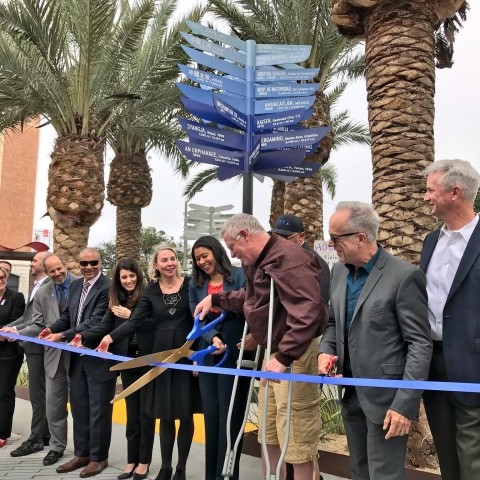 Elected officials cutting a ribbon at Geary and Masonic