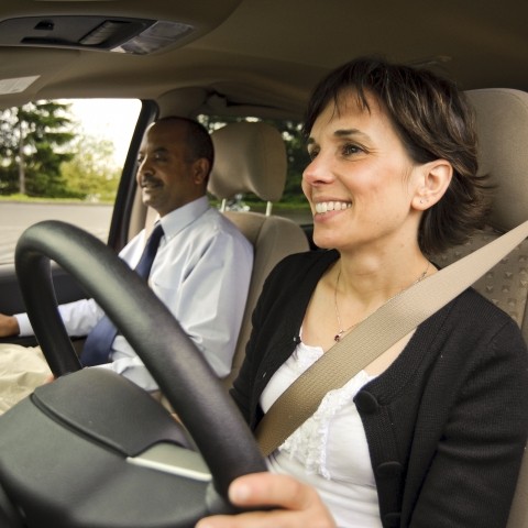 A woman driving a vanpool