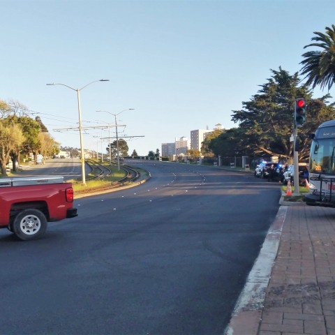 A car and bus driving on the new repaved street