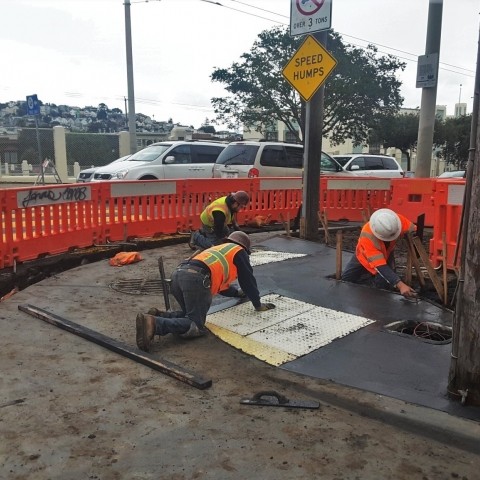 construction workers building a curb ramp