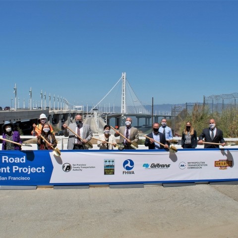 project managers holding up banner