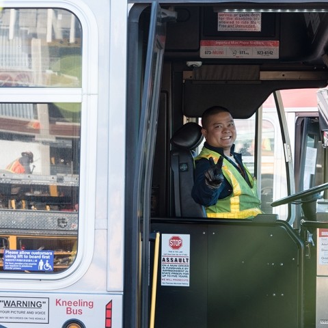 SFMTA Muni bus driver holding up peace sign