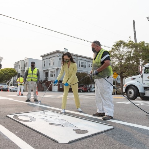 Transportation Authority Board Member Connie Chain and SFMTA staff adding bike lane indication on Anza Street