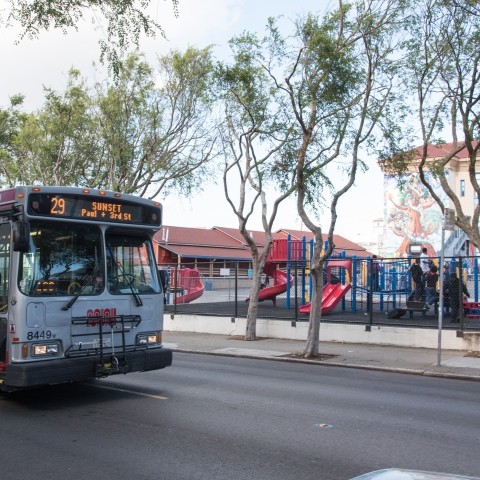 Muni bus driving past school yard