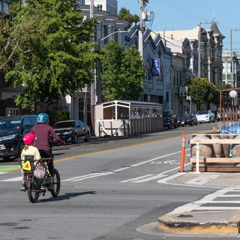 Bicyclist with child on bike on road