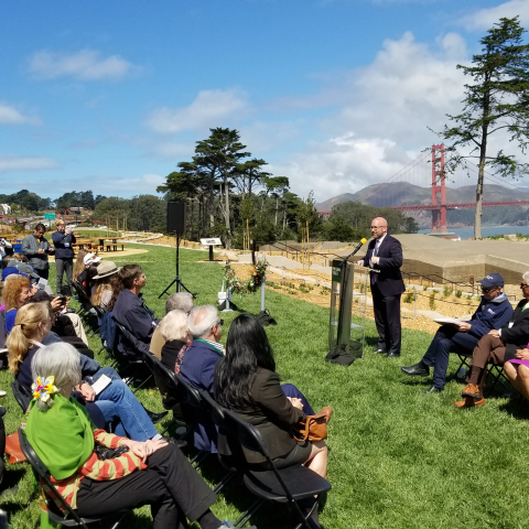 Transportation Authority Board Chair Rafael Mandelman speaking to crowd in the Presidio