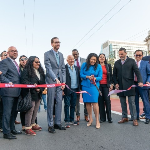 People cutting ribbon for celebration