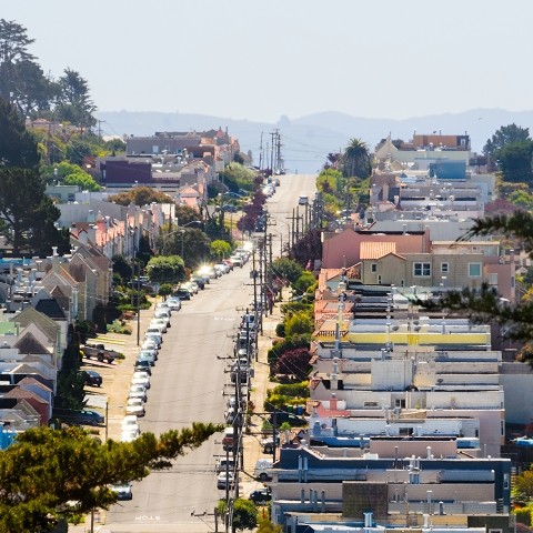 A view of a hilly street in the Inner Sunset, seen zoomed-in from a distance