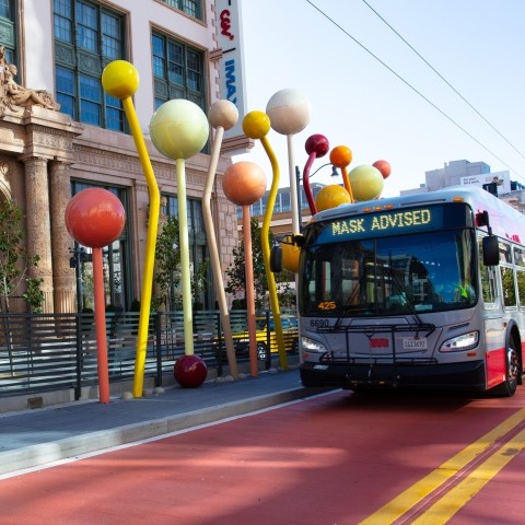 Van Ness bus rapid transit in front of outdoor art. 