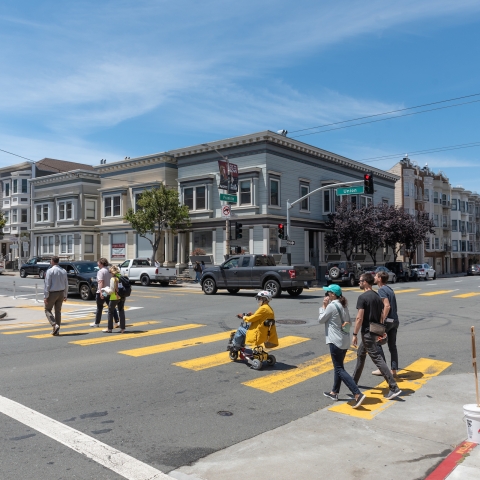 Pedestrians and wheelchair user in crosswalk by Franklin and Union Streets