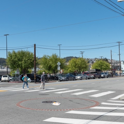 Intersection of Apollo and Williams in the Bayview District, pedestrians cross in crosswalk 