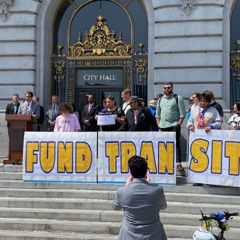 City leaders and advocates at a rally to prioritize transit funding, on the steps of San Francisco's City Hall 