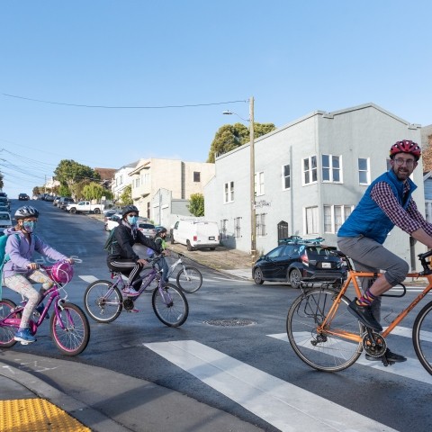 Adult and children biking in the Excelsior neighborhood