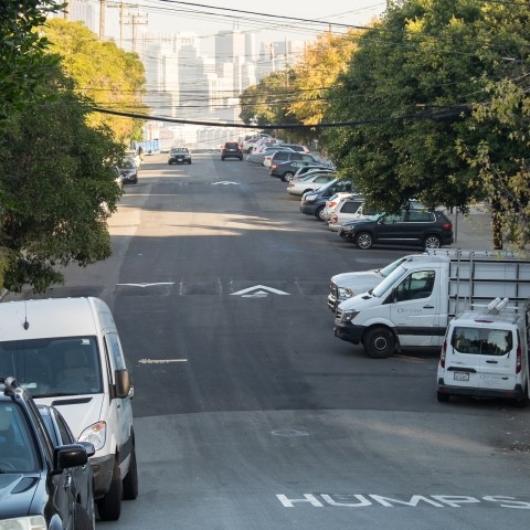 speed humps along road with cars parked