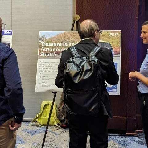 TA staff speaking with participants about the Treasure Island Autonomous Shuttle Pilot 