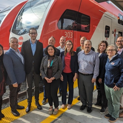 Group shot in front of new electric train