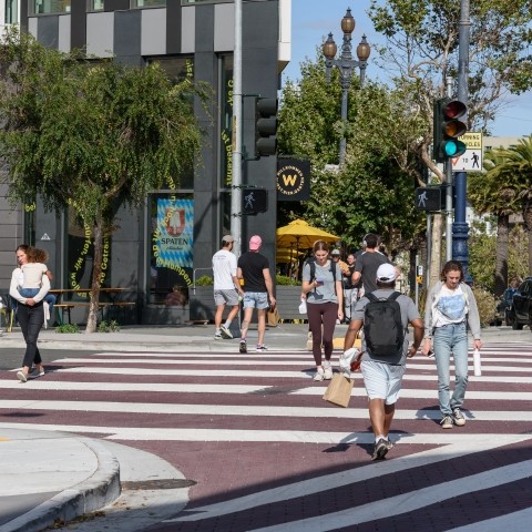 Pedestrians walking in crosswalk along Market Street