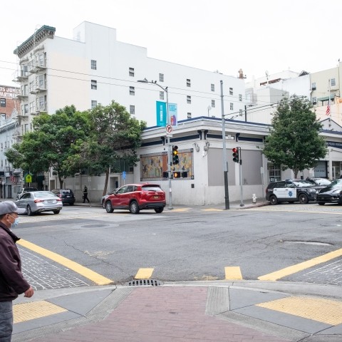 Pedestrians on a sidewalk waiting to cross the street