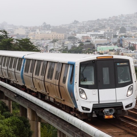 A BART train on overhead tracks traveling through San Francisco