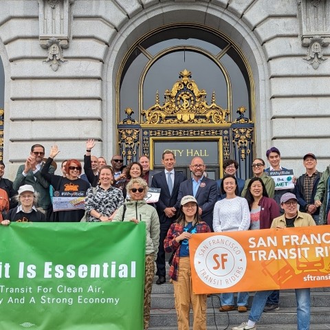 People gathered on the steps of City Hall to celebrate Transit Month