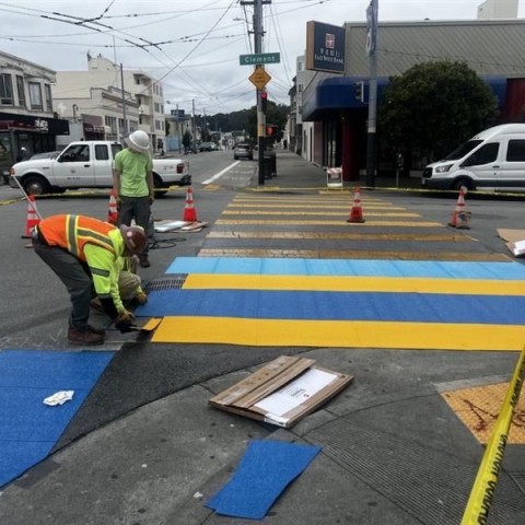 SF Public Works' workers painting a decorative crosswalk along 6th Avenue and Clement Street
