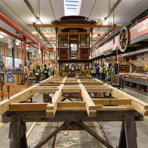 Cable car elevated in SFMTA restoration workshop 