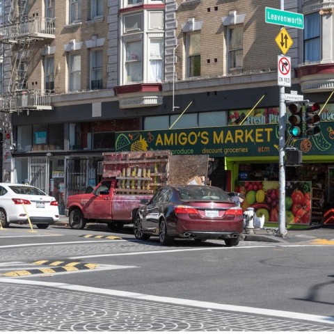 Car making left turn with waist-high delineators and speed bumps
