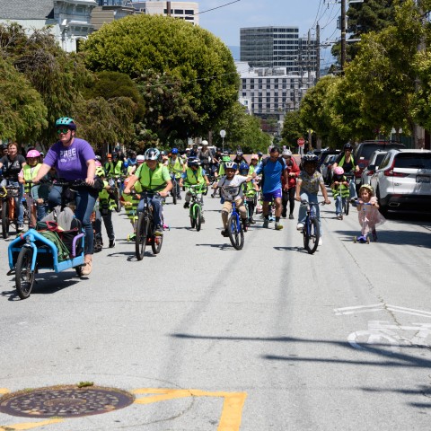 Students and adults on group bike ride